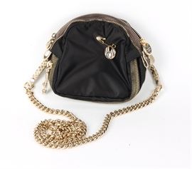 Henri Bendel Crossbody Purse: A Henri Bendel crossbody purse. This purse features a black fabric body with gold-tone hardware and a gold-tone chain strap. This piece shows maker’s marks to the zipper and interior.