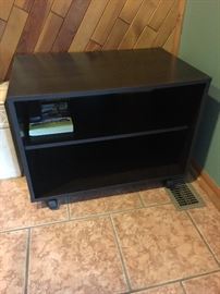 Black wooden TV stand on wheels