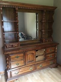 Mirrored dresser with lots of drawers and shelves