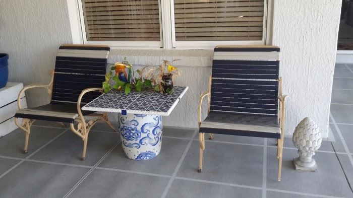 Navy and Beige Vinyl Strap Metal Chairs, Tile Table Top with Ceramic Base, Concrete Outside Decor