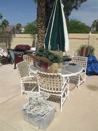 Glass-top patio table with four chairs