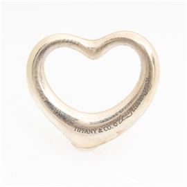Tiffany & Co. Sterling Silver Heart Pendant: A Tiffany & Co. sterling silver heart pendant. The pendant is an open, rounded heart and is marked with the Tiffany & Co. name along with the Peretti signature and “Spain 925”. The total approximate weight is 0.134 ozt; measures approximately .75” long.