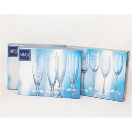 Mikasa "Cheers" Glass Three Box Sets: A collection of Mikasa Cheers glasses. Included are two sets of pilsner, and one set of wine glasses. Each set features a geometric etch pattern to the bowls.