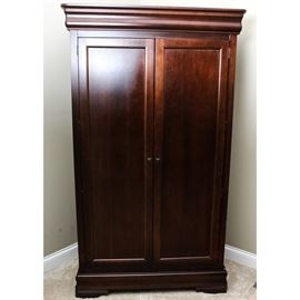Broyhill "Maison Lenoir" Wardrobe: A Broyhill Maison Lenoir wardrobe. This two-door piece in a mahogany finish comes with a clothing rod, two shelves, two drawers and features decorative escutcheons, and bracket feet. This piece coordinates with items 17COL054-051, 17COL054-052, 17COL054-053, 17COL054-054 also found in this sale.