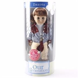 Our Generation "Dakota" Doll: A toy doll by Our Generation. Featured is an 18" doll with brown hair, brown eyes, and fabric clothing. The doll is labeled as “Dakota” and “A Complete Line of Equestrian Dolls & Accessories With Bendable Knees!”.