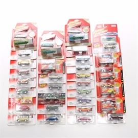 Johnny Lightning Die-Cast Cars: A group of Johnny Lightning die-cast cars. This group of thirty-one Johnny Lightning die-cast cars features a 1969 Dodge Daytona with functioning hood. Additional cars include a 1971 Plymouth Roadrunner with functioning hood, a 1966 Volkswagen Beetle, a 1965 Buick Riviera and more.