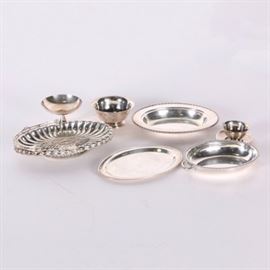 Reed & Barton Bowl and Other American Silver Plate Servingware: A collection of American silver plate serving ware. This includes two “Paul Revere” bowls by Poole Silver Co. and Reed & Barton, a saucer by New Amsterdam Silver Co, an ornate pedestalled server marked “L917”, a lidded oval tray by the Middletown Silver Co., and an oval tray by the Homan Manufacturing Co. Most of the items feature personalized engravings.
