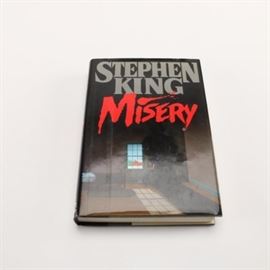 1987 First Edition Stephen King "Misery": A first edition of Stephen King’s horror novel Misery. This book was published in 1987 under Penguin’s Viking imprint. The book is a hardcover with a color dust jacket.