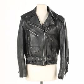 Women's Gino Leathers Fringe Leather Jacket: A women’s Gino Leathers fringe leather jacket. This motorcycle jacket features snaps to collar, shoulder epaulettes, zippered and buttoned front pockets with attached belt, front zipper closure, and black polyester lining. The back of the jacket is decorated with fringe. It is labeled to the interior “Gino Leathers” and “Cowhide”.