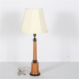 Mid-Century Metal and Crackle Glass Table Lamp: A mid-century metal and crackle glass table lamp. The lamp features an orange metal base, a clear crackle glass overlay, ringed black metal detailing near the base and socket, and a canvas shade. The lamp operates via use of a rotary switch near the socket. Matches identical lamp being sold as item 17WDC048-016.