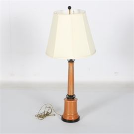 Mid-Century Metal and Crackle Glass Table Lamp: A mid-century metal and crackle glass table lamp. The lamp features an orange metal base, a clear crackle glass overlay, ringed black metal detailing near the base and socket, and a canvas shade. The lamp operates via use of a rotary switch near the socket. Matches identical lamp being sold as item 17WDC048-015.
