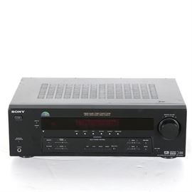 Sony "HT-DDW650" Home Theater System: A Sony HT-DDW650 home theater system. This device supports a wide array of home entertainment devices with inputs for RCA cable, speaker wire, optical cable, AM/FM antennas, coaxial cable, component video, and others. Features a control panel to front with controls for adjusting video and audio quality on all connected devices. Item is prominently marked “Sony” to upper left corner of front, and reads “Digital Audio/Video Control Center – Digital Cinema Sound-Cinema Studio EX” to upper center.