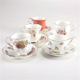 Collection of Crown Staffordshire China Teacups and Saucers: A collection of china teacups and saucers by Crown Staffordshire. This selection includes five sets with floral and foliage designs and gilt trim. It features a teacup and saucer in the Floral Bouquet pattern, and more. These pieces are all stamped to the undersides “Crown Staffordshire Fine Bone China, Est. 1801, England”.