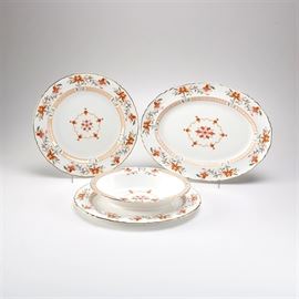 Royal Worcester "Chamberlain" Dishes: A group of porcelain dishes in the Chamberlain pattern by Royal Worcester. There are four items in total with a larger oval serving platter, a smaller oval serving platter, an oval serving bowl, and a round platter. They feature orange floral medallions surrounded by floral trim. The underside of one reads, “Royal Worcester Fine Bone China 1967 Royal Worcester Chamberlain as designed for the Prince Regent 1811”.