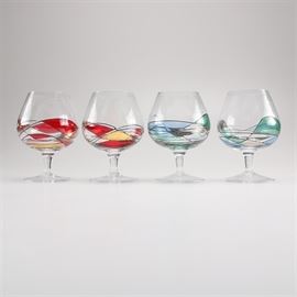 Crystal Artistic Brandy Snifters: A selection of four brandy snifters. These crystal snifters feature painted detailing around the bottom of each glass. Two glasses offer red and gold tones, and two offer blue, green, and silver tones. No signatures or marks are present.