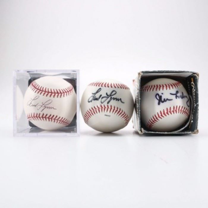 Autographed Baseballs: An assortment of autographed baseballs. This assortment of three autographed baseballs features a baseball with the Boston Red Sox logo signed by Jim Leyritz. Additional items include two baseballs signed by Fred Lynn.