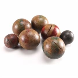 Vintage Bocci Balls: A collection of assorted vintage bocci balls. Made of wood, this selection features five large red and green balls, and two smaller balls. All pieces are unmarked.