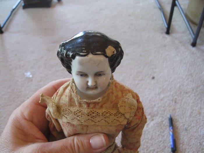 Vintage China doll has blue eyes - small chip on head