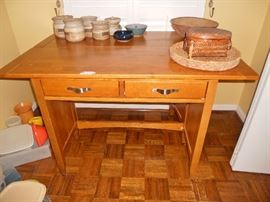 Utilitarian kitchen table with 2 drawers--top folds over onto itself to utilize space