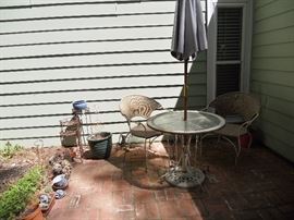 Outdoor patio table with umbrella--measures approximately 36"                                                                    Two patio chairs--metal base with woven backs and seats