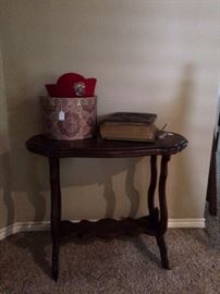 Small antique table; vintage hat and hat box; Holy Bible