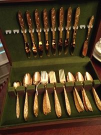 Set of gold colored flatware & chest 
