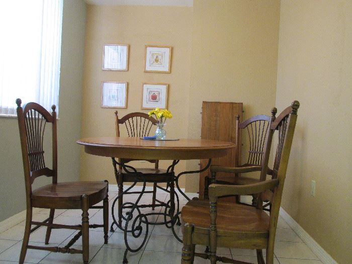 Ethan Allen Round kitchen table with one extra leaf, arm chair, three no-arm chair. Wrought iron table base and oak wood (chairs and table) diam 46" start price$400.00