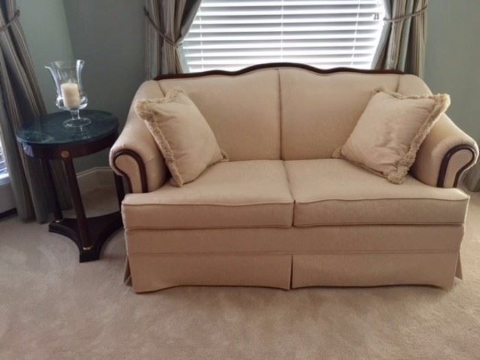Broyhill love seat cream with mahogany details around the frame. 