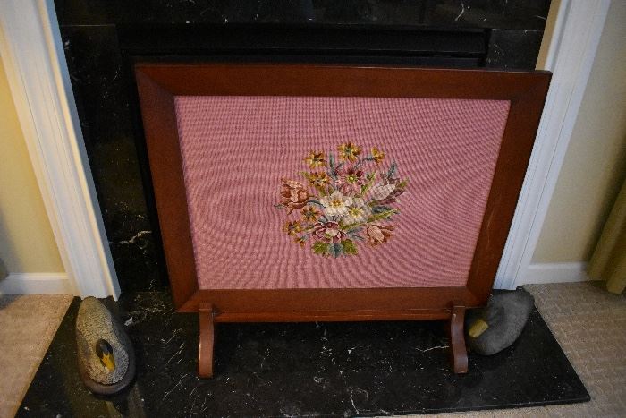 Wonder needle work floral design placed in the center of a unique fireplace screen