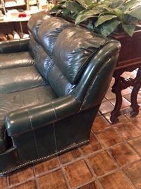 Green 3-cushioned leather sofa; behind - long copper lined planter
