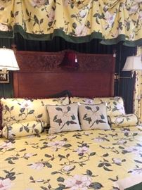 A king bed with full headboard; magnolia bedding