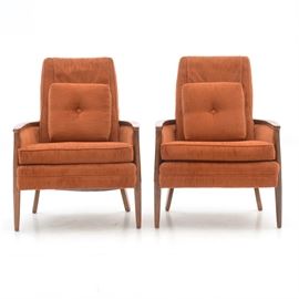 Pair of Vintage Burnt Orange Armchairs: A pair of circa 1970s vintage armchairs, upholstered in burnt orange fabric with hardwood frames. Each has a dust cover to the top and includes a throw pillow.