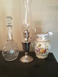 A crystal decanter. A silverplate oil lamp. Lenox porcelain pitcher