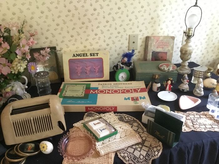 A table top full of vintage games, radio, lamps and so much more