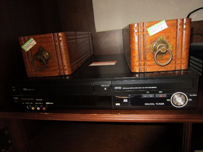 One of a few DVD players and two Singer Sewing Machine Drawers.