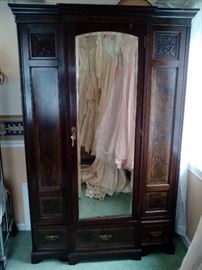 Antique 1860's-70's Walnut and Mahogany Armoire/Wardrobe with hand carved panels. Mirrored front with 3 drawers with hanging rail and orginal hooks. 51"wide 22"deep 77"tall $170.00