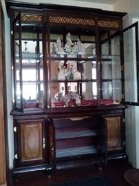 2 piece lighted china cabinet with Glass shelves on top. 2 shelves on the bottom with a pull out lined silverware drawer 65"wide 17.5"deep 84"tall $150.00