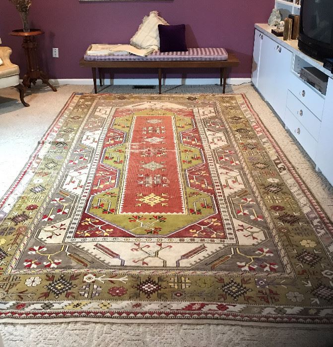 Turkish rug and mid-century slotted bench with cushion