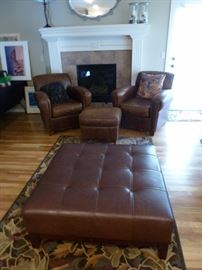 Square leather ottoman, matching leather chairs and small ottoman, area rug, & Lazyboy loveseat