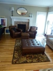 Square leather ottoman, matching leather chairs and small ottoman, area rug, & Lazyboy loveseat