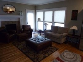 Square leather ottoman, matching leather chairs and small ottoman, area rug, & Lazyboy loveseat