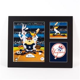 Yogi Berra Signed Looney Tunes "At the Plate" New York Yankees Lithograph: A limited edition Looney Tunes lithograph titled At the Plate, signed by Yogi Berra. It depicts Bugs Bunny, Daffy Duck, and the Tasmanian Devil in Yankees uniforms, all standing behind home plate, an image of Daffy at bat, and the Yankees logo. All three images are set in black matting and come in a plastic sleeve with a Classic Moments certificate of authenticity. The largest image is hand signed by Yogi Berra (1925-2015), who played for the New York Yankees from 1946 to 1963.