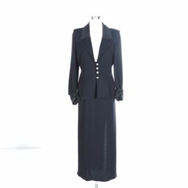 St. John Skirt Suit: A St. John skirt suit. This outfit features a black knit skirt marked “St. John Evening by Marie Gray” to the label. Also included is a matching black knit jacket with four rhinestone encrusted buttons marked “St. John Evening by Marie Gray” to the label.