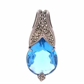 Sterling Silver Marcasite and Faceted Blue Glass Pendant: A sterling silver pendant. This piece features a pear-shaped faceted blue glass pendant in a marcasite-enhanced setting. This item is hallmarked “925” and has a total approximate weight, inclusive of all materials, of 0.460 ozt.