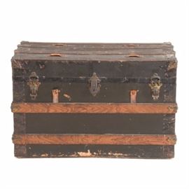 Antique Steamer Trunk: A circa 1900 antique steamer trunk. The trunk features black painted wood, unpainted wood banding, and metal corner caps. The interior is lined with paper and features a removable tray.