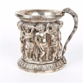 Sterling Silver Renaissance Style Cherub Double Lined Mug: A large Renaissance style sterling silver double lined mug. The mug with round base and lip is enhanced by a highly raised repousse center of putto. The handle is comprised of a twisted vine with leaf detail. The bottom rim of the mug is stamped “925” and weighs approximately 32.335 ozt.
