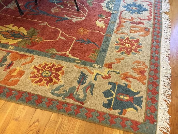 Persian Heriz rug with  brick colored center and ivory and blue border 	9’ x 12’, 20th c