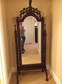 Free - standing full length mirror with ornate wood trim