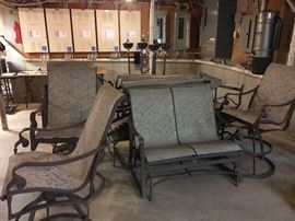 Patio furnishings, including:  Rectangular table w/ umbrella, (4) rocking swivel chairs, settee, lounge chairs w/ wheels (2) and end 
tables (3)