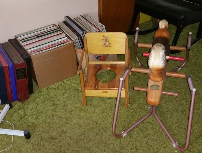 Bouncy hobby horse, vintage potty seat. Record albums.